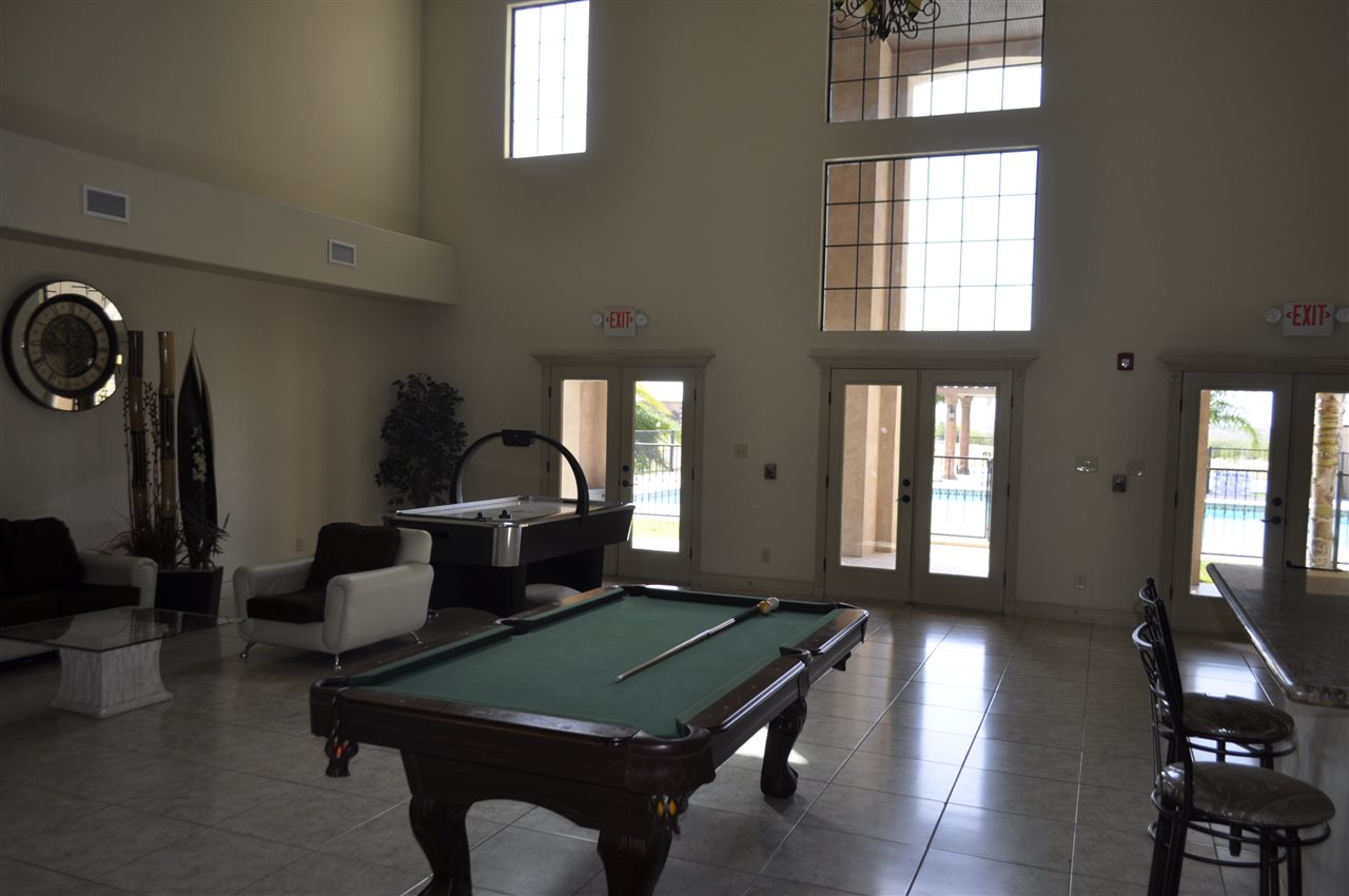 8216 Casa Verde Road, Unit E158 Laredo, TX 78041 - Photo 13 of 20 a living room with furniture a chandelier and a window