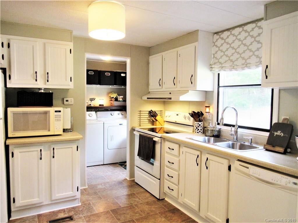 2172 Mission Road York, SC 29745 - Photo 8 of 30 a kitchen with white cabinets and white appliances