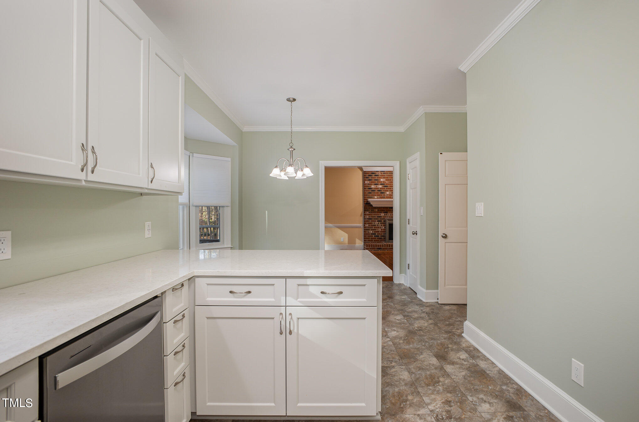 2212 Millpine Drive Raleigh, NC 27614 - Photo 12 of 31 a kitchen with white cabinets and white appliances
