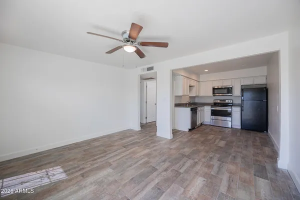 a view of a kitchen with a sink stainless steel appliances and cabinets