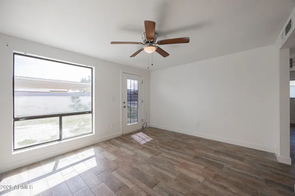 wooden floor in an empty room with a window