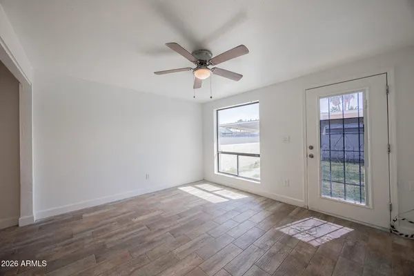 wooden floor in an empty room with a window