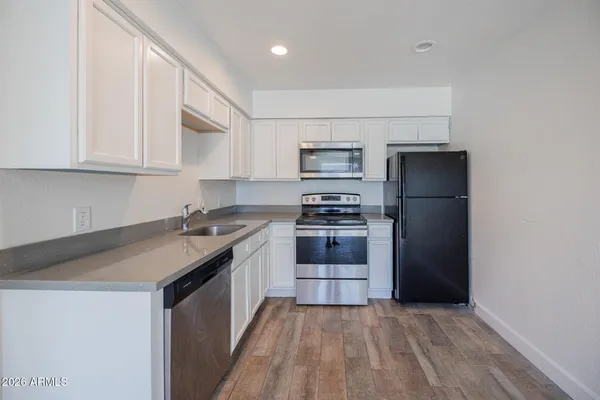 a kitchen with a sink stove and refrigerator