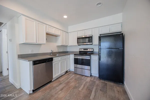 a kitchen with a refrigerator stove and microwave