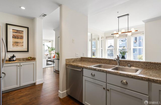 a kitchen with granite countertop a sink and a stove