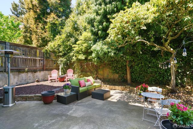 a backyard of a house with fire pit and outdoor seating