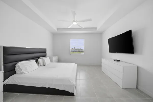a bedroom with a bed and a flat tv screen