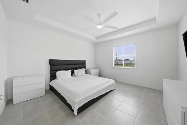 a bedroom with a bed and a night stand