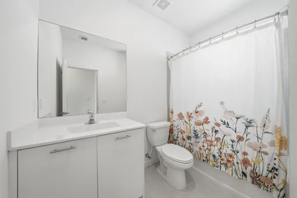 a bathroom with a toilet a sink and a mirror