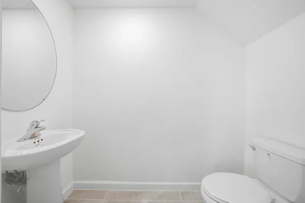 a bathroom with a sink a toilet and mirror