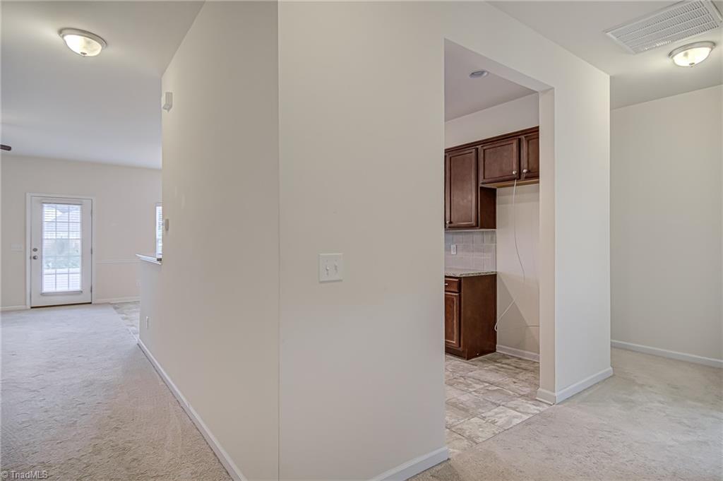 588 Forage Drive High Point, NC 27265 - Photo 5 of 33 As you walk to the hallway from foyer, you will see the kitchen, living area, and dining area. Door leads to screened porch!