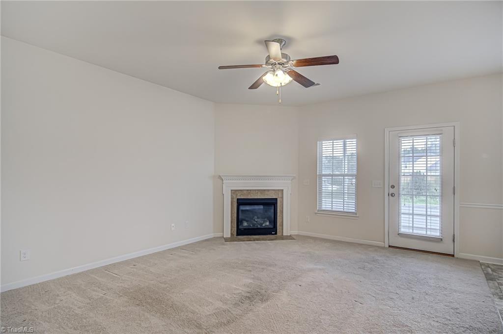 588 Forage Drive High Point, NC 27265 - Photo 6 of 33 Cozy living room features gas log fireplace, ceiling fan, glass doors and big windows for plenty of natural light!