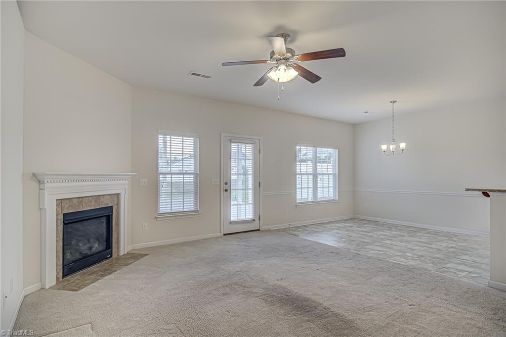 588 Forage Drive High Point, NC 27265 - Photo 7 of 33 Living area is flooded by natural light. Fireplace gives out cozy vibes!