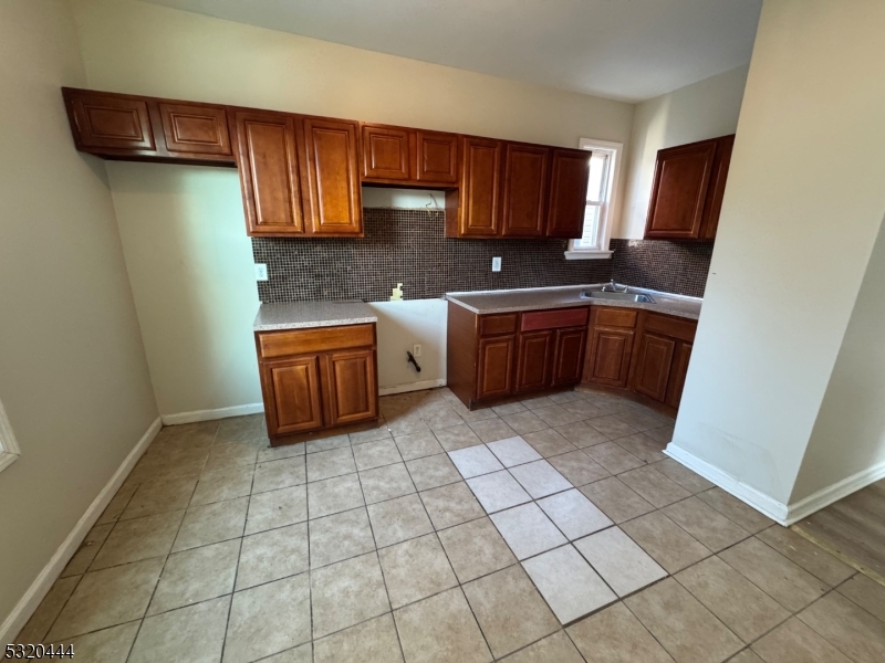 285 Wainwright Street Newark, NJ 07112 - Photo 13 of 27 a kitchen with stainless steel appliances granite countertop a sink stove and cabinets