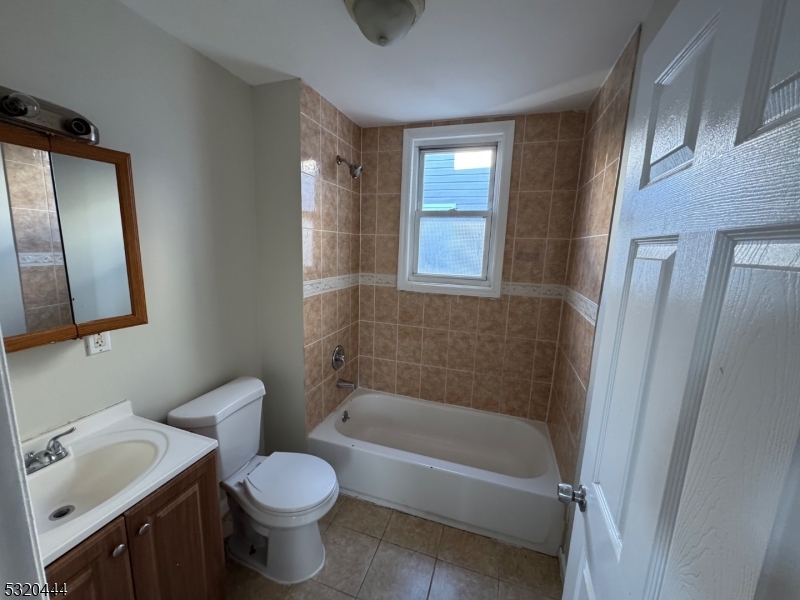 285 Wainwright Street Newark, NJ 07112 - Photo 15 of 27 a bathroom with a sink toilet and shower