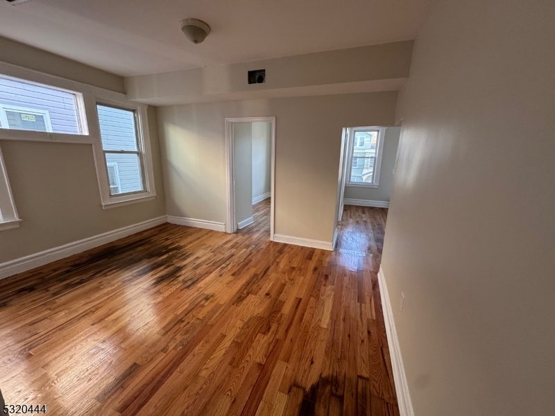 285 Wainwright Street Newark, NJ 07112 - Photo 17 of 27 a view of wooden floor and windows in a room