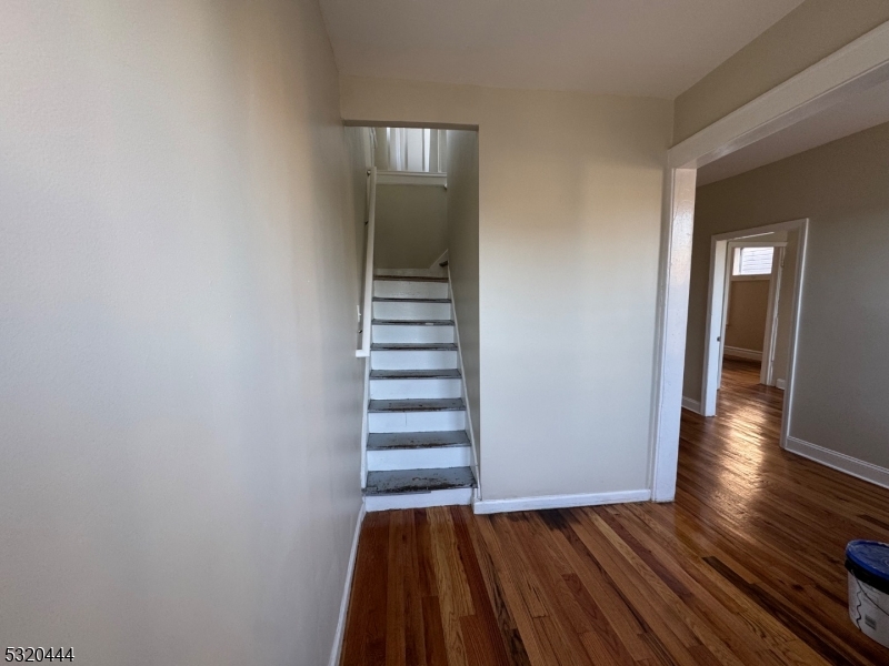 285 Wainwright Street Newark, NJ 07112 - Photo 20 of 27 a view of a room with wooden floor and stairs