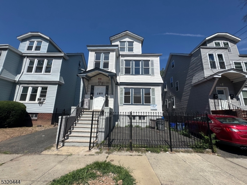 285 Wainwright Street Newark, NJ 07112 - Photo 27 of 27 a front view of a residential apartment building with a yard