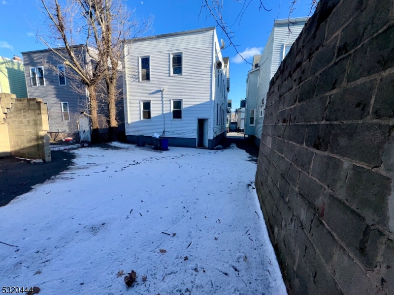 285 Wainwright Street Newark, NJ 07112 - Photo 4 of 27 a view of a house with a wooden fence