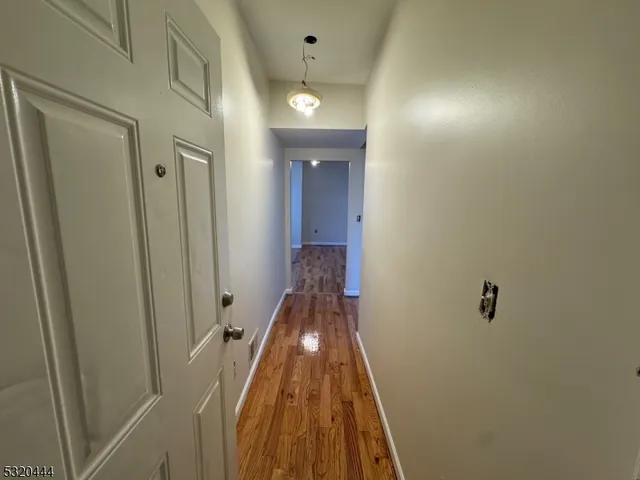 a view of a hallway with a door