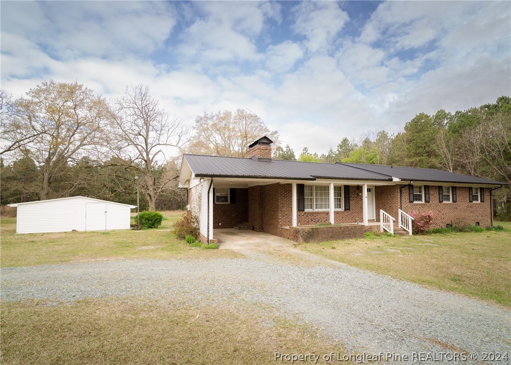 141 Union Church Road Carthage, NC 28327 - Photo 3 of 31 a view of a house with a yard and large trees