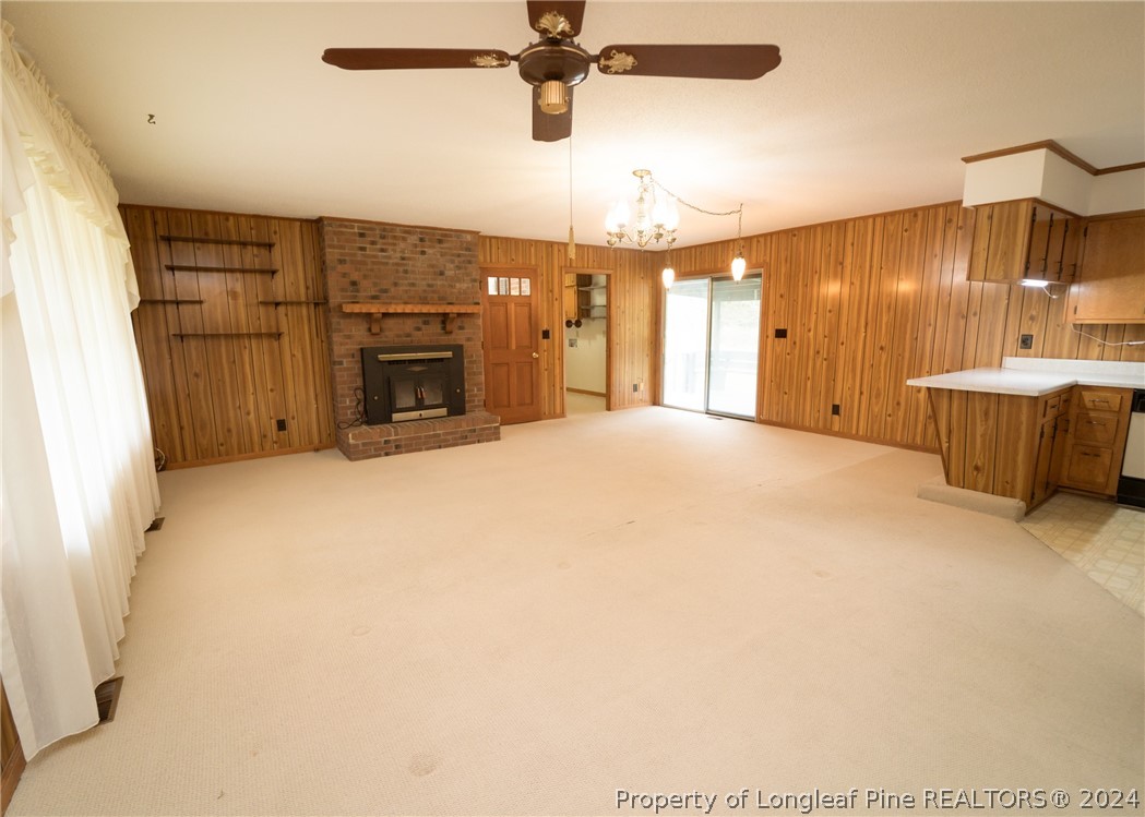 141 Union Church Road Carthage, NC 28327 - Photo 6 of 31 a view of a livingroom with a fireplace and chandelier