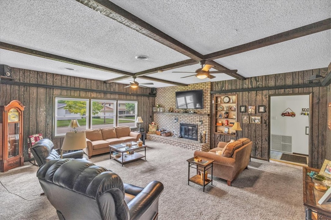 2220 West Ravina Park Road Decatur, IL 62526 - Photo 12 of 36 a living room with furniture a fireplace and a large window