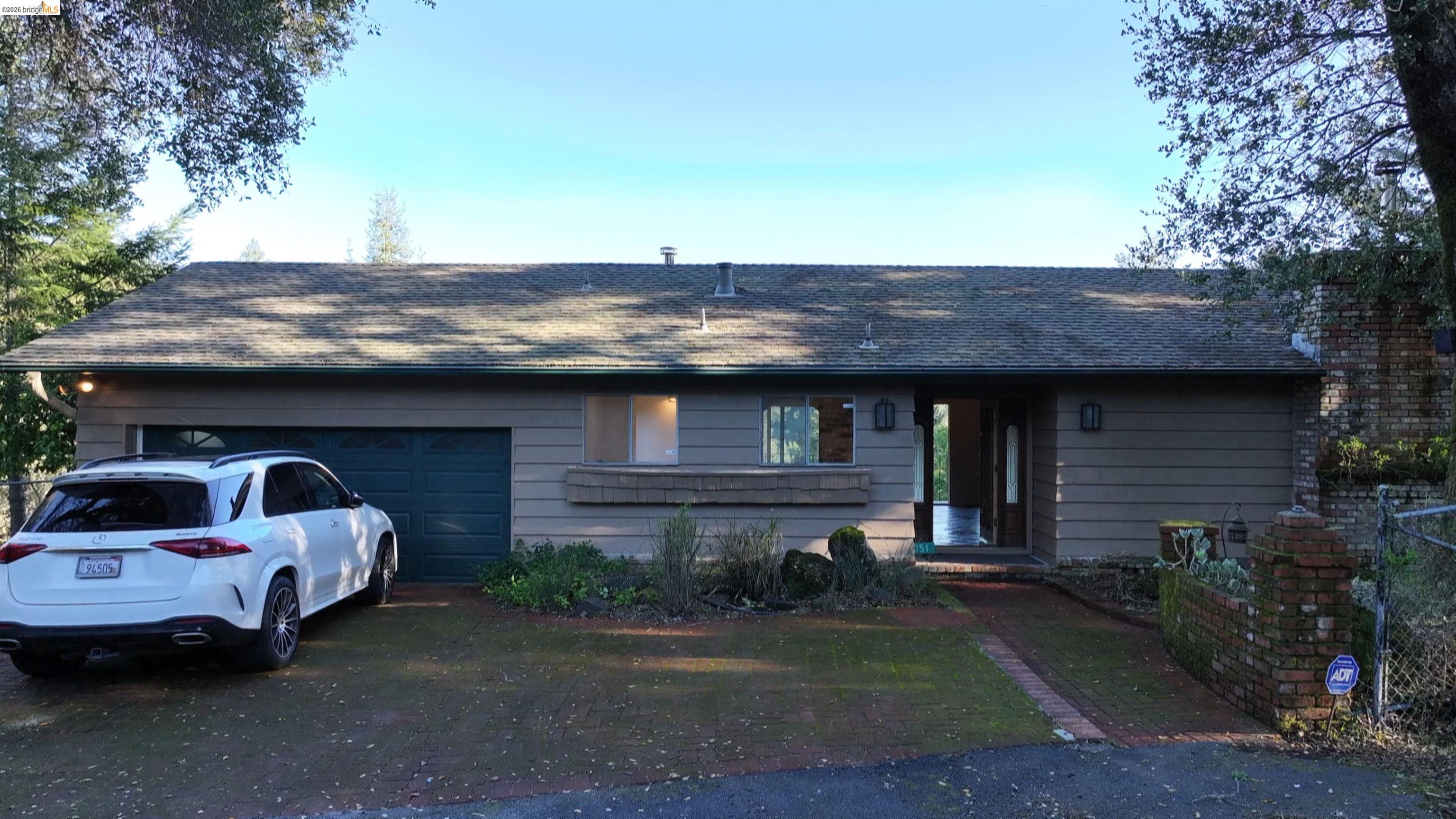 5051 Harrison Grade Road Sebastopol, CA 95472 - Photo 3 of 31 a front view of a house with parking area