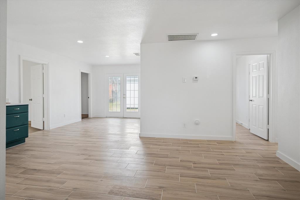 1809 Dunning Street Irving, TX 75061 - Photo 16 of 35 a view of an empty room with wooden floor and a window