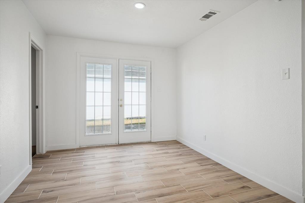 1809 Dunning Street Irving, TX 75061 - Photo 18 of 35 an empty room with wooden floor and windows