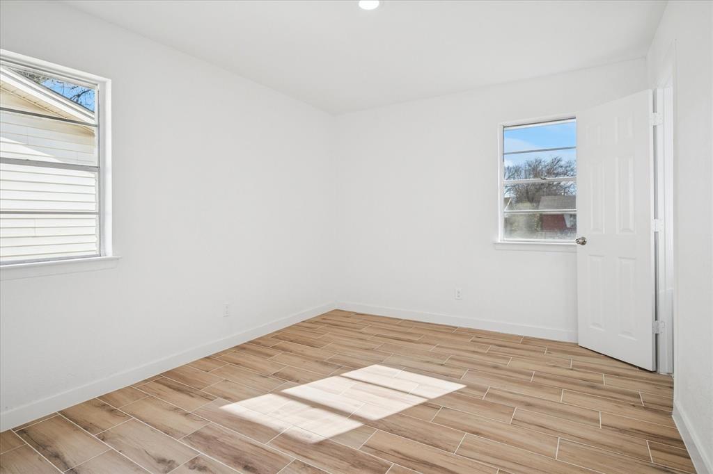 1809 Dunning Street Irving, TX 75061 - Photo 20 of 35 a view of a room with wooden floor and a window