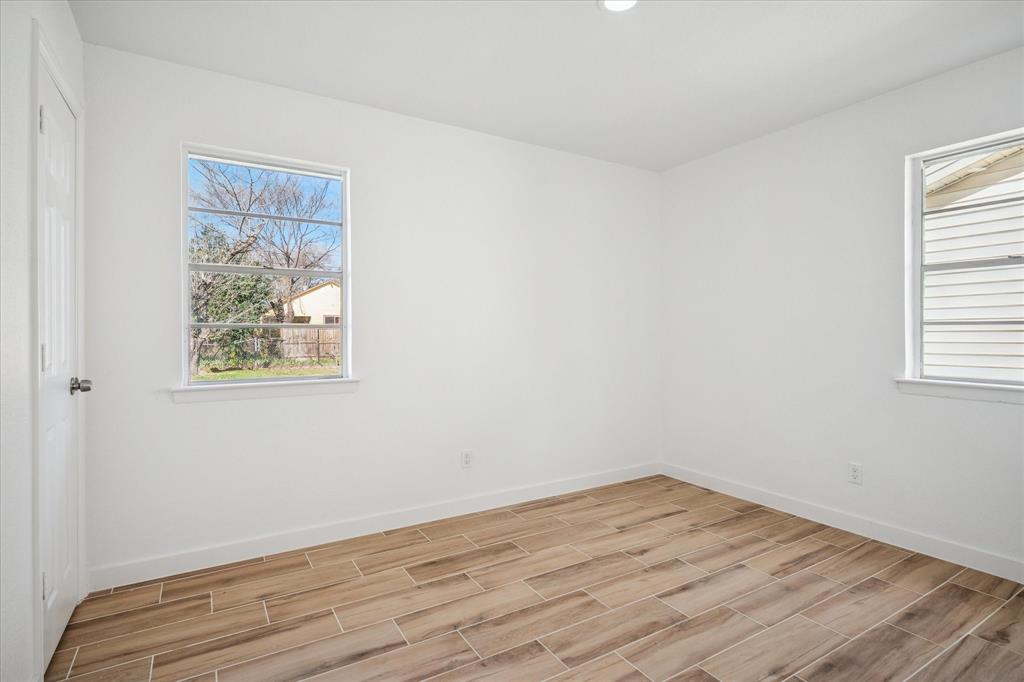 1809 Dunning Street Irving, TX 75061 - Photo 22 of 35 an empty room with wooden floor and window