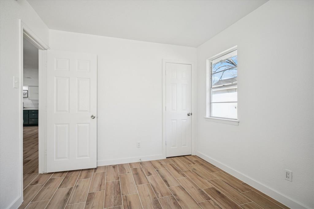1809 Dunning Street Irving, TX 75061 - Photo 23 of 35 an empty room with wooden floor and windows