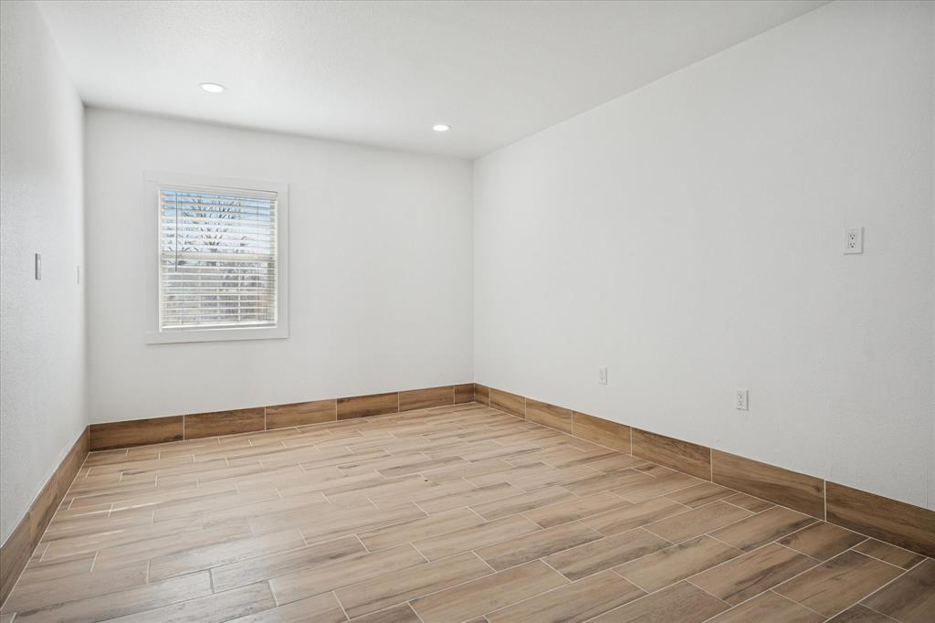 1809 Dunning Street Irving, TX 75061 - Photo 26 of 35 an empty room with wooden floor and windows