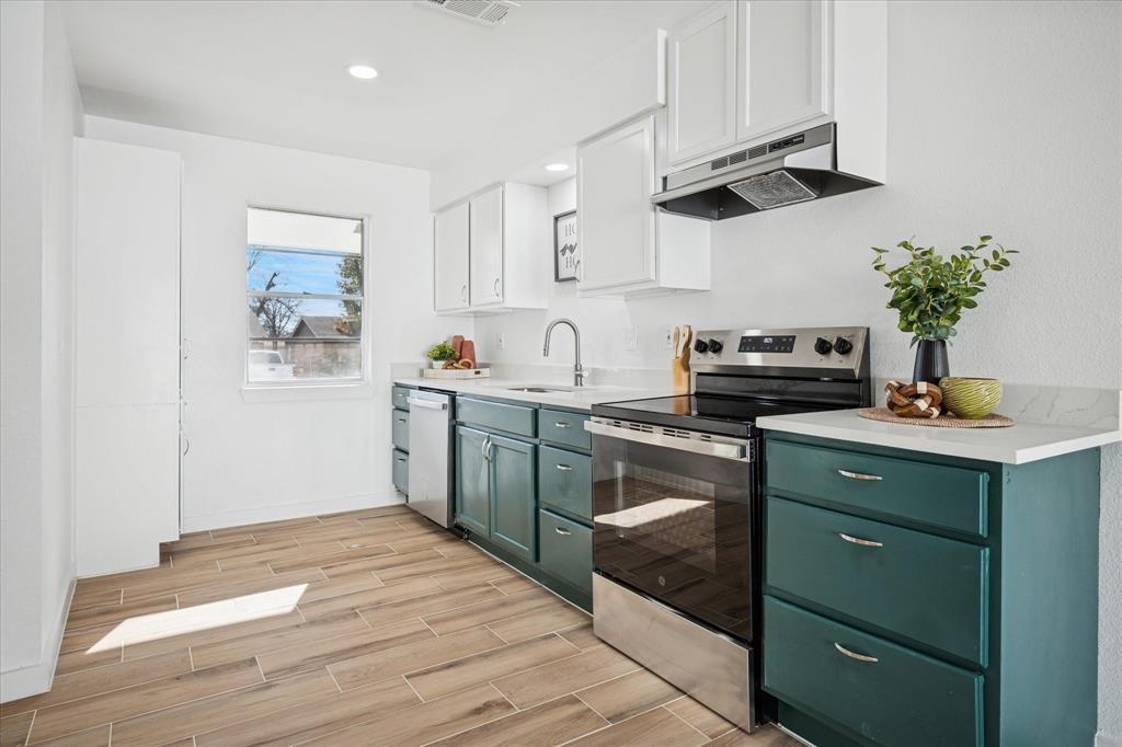 1809 Dunning Street Irving, TX 75061 - Photo 3 of 35 a kitchen with a sink and cabinets