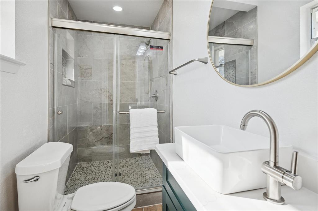 1809 Dunning Street Irving, TX 75061 - Photo 7 of 35 a bathroom with a sink toilet and shower