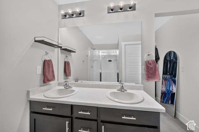 1081 Bowery Way Mapleton, UT 84664 - Photo 25 of 41 Dual vanity with integral sinks, light-toned countertop, and dark wood-finish cabinetry