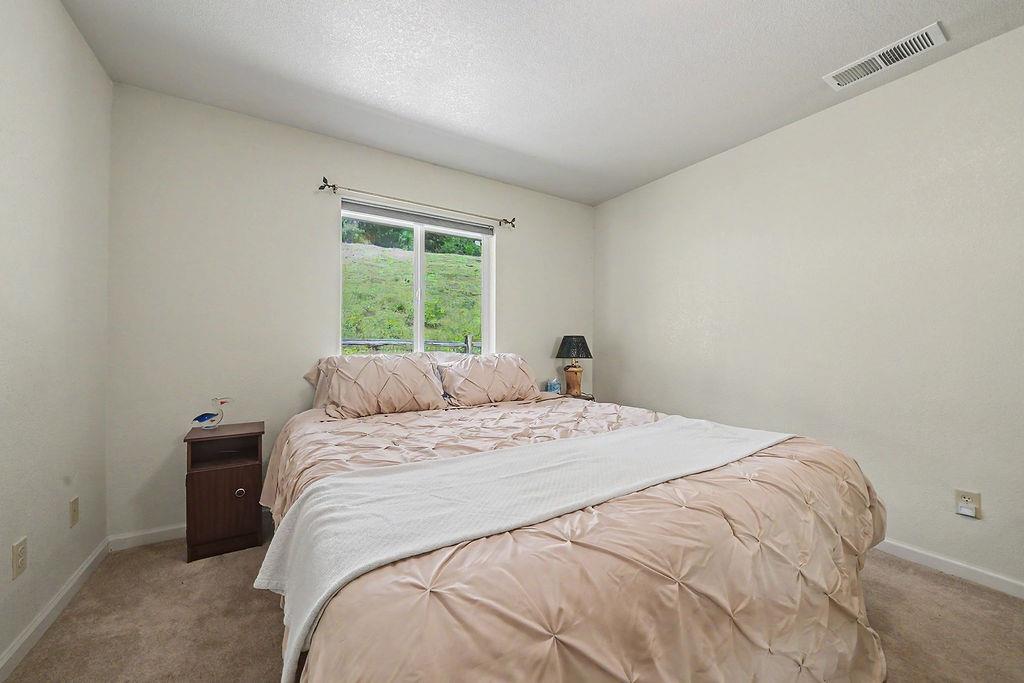 26845 Spring Court Pioneer, CA 95666 - Photo 31 of 89 a bed sitting in a bedroom next to a window