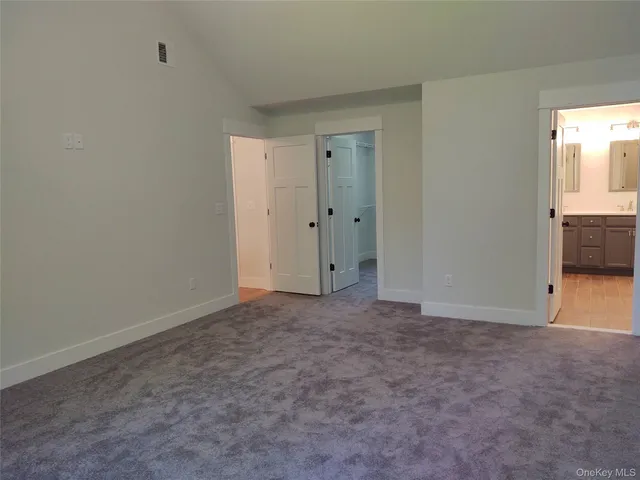 a bathroom with a double vanity sink a mirror and bathtub