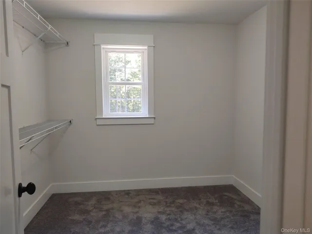 a bathroom with a granite countertop sink a window and a mirror