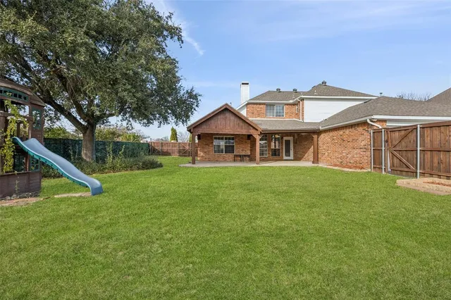 a view of a house with a yard and sitting area