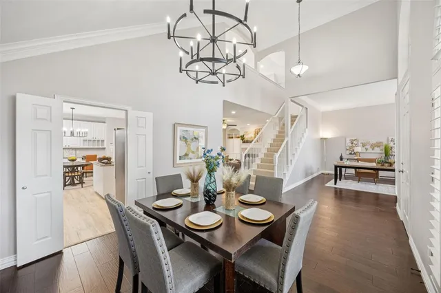 a view of a dining room with furniture wooden floor and chandelier