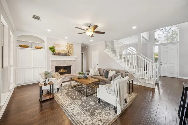 a living room with furniture fireplace and wooden floor