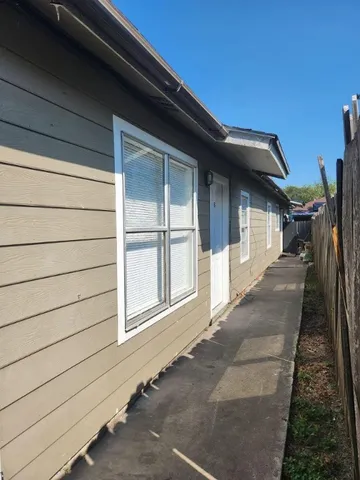 a view of a house with a wooden deck