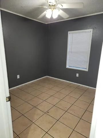 a view of a livingroom with an empty space and a window