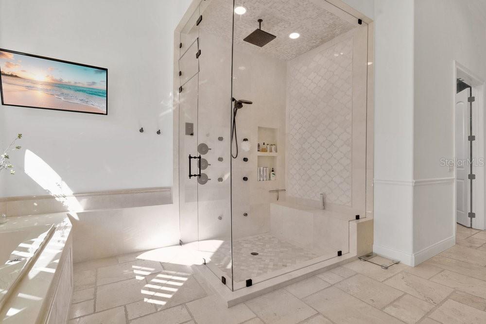 9204 Tibet Pointe Circle Windermere, FL 34786 - Photo 21 of 72 a bathroom with a glass shower door