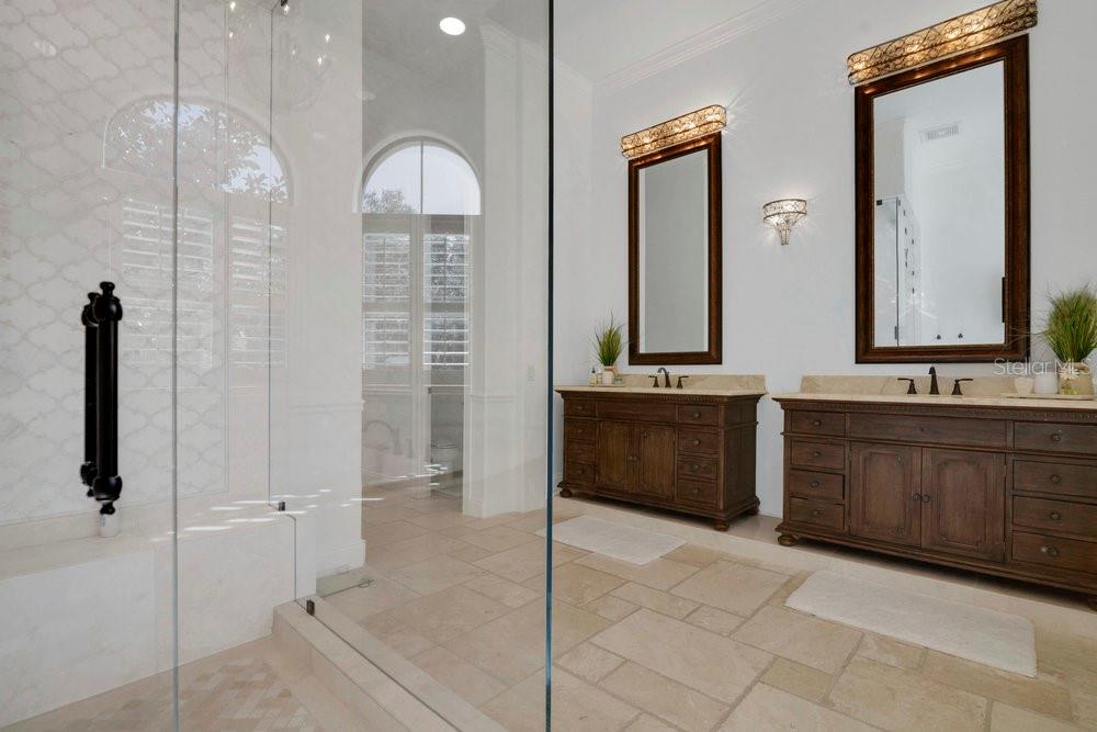 9204 Tibet Pointe Circle Windermere, FL 34786 - Photo 22 of 72 a bathroom with a double vanity sink a mirror and a bathtub