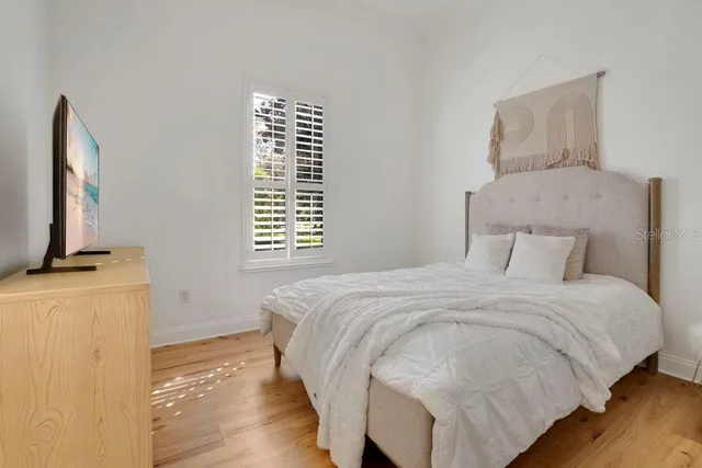a view of an empty room with wooden floor