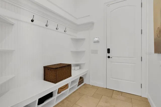 a living room with furniture and large windows