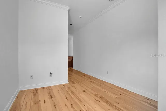a view of a backyard with table and chairs under an umbrella